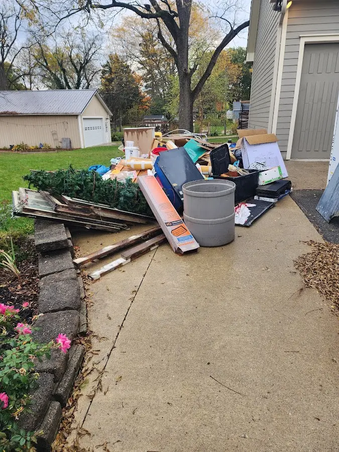 Dumpster being loaded with debris for Roofing Dumpster Rental in Forrest City